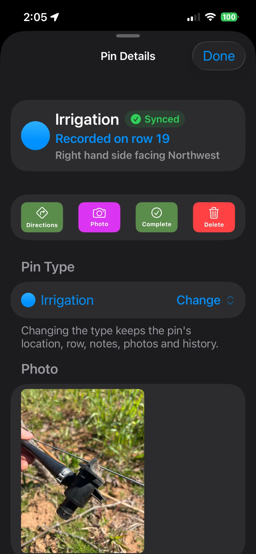 VineTrack pin details screen showing a synced irrigation pin recorded on row 19 with directions, photo, complete and delete actions and an attached photo of a damaged sprinkler
